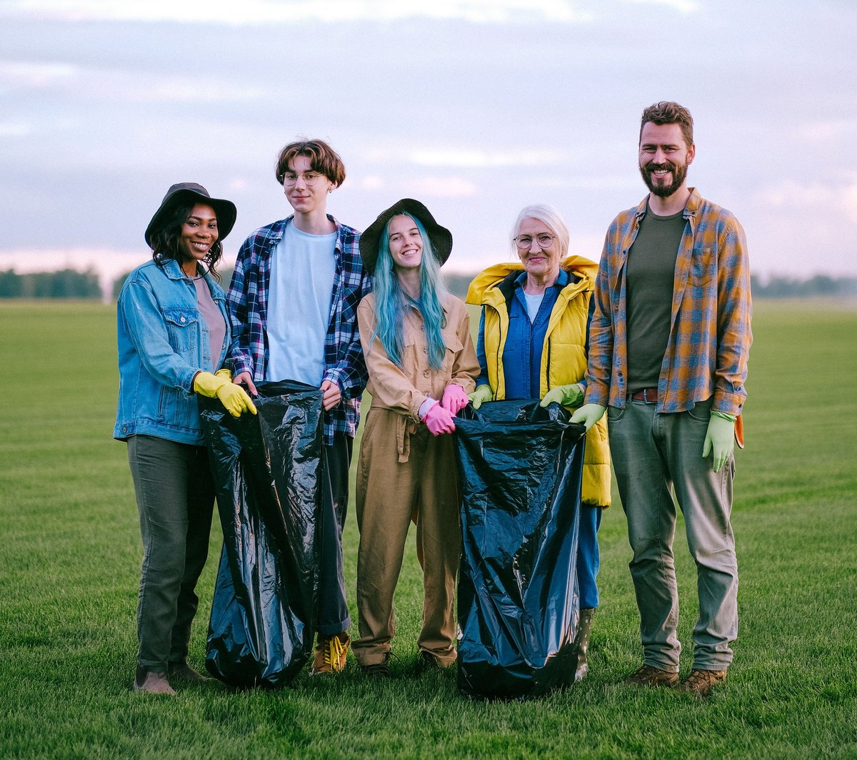 Volunteer team smiling during an outdoor cleanup