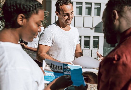 Volunteers reviewing materials at an outdoor event