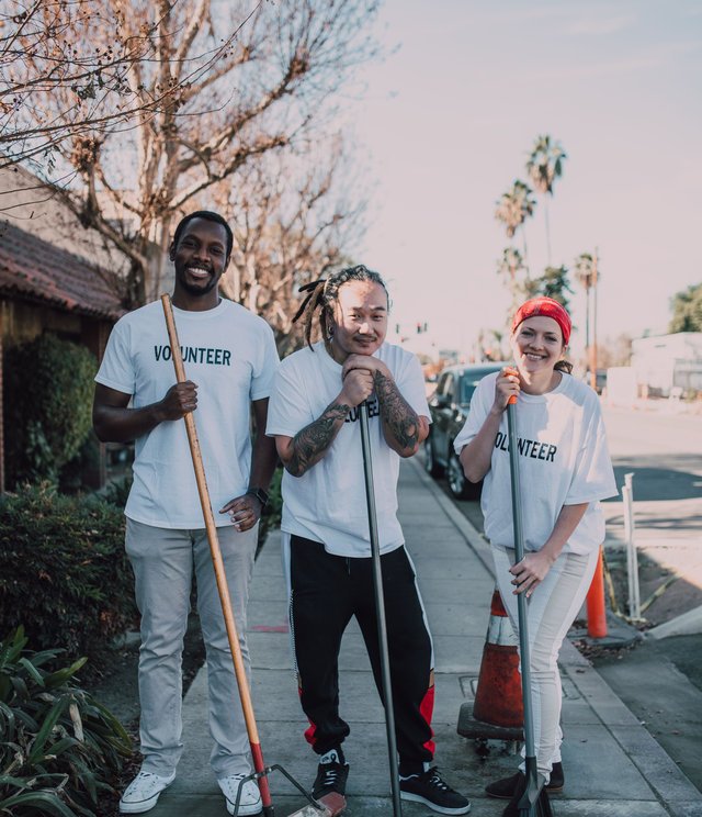 Volunteers with cleaning tools on a city street