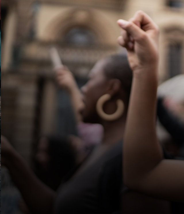 Person raising a fist at a community gathering